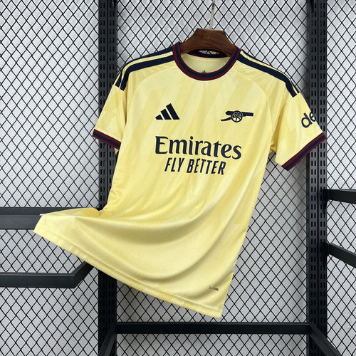 Yellow football shirt with navy trim, Emirates sponsor, and Arsenal badge on chest