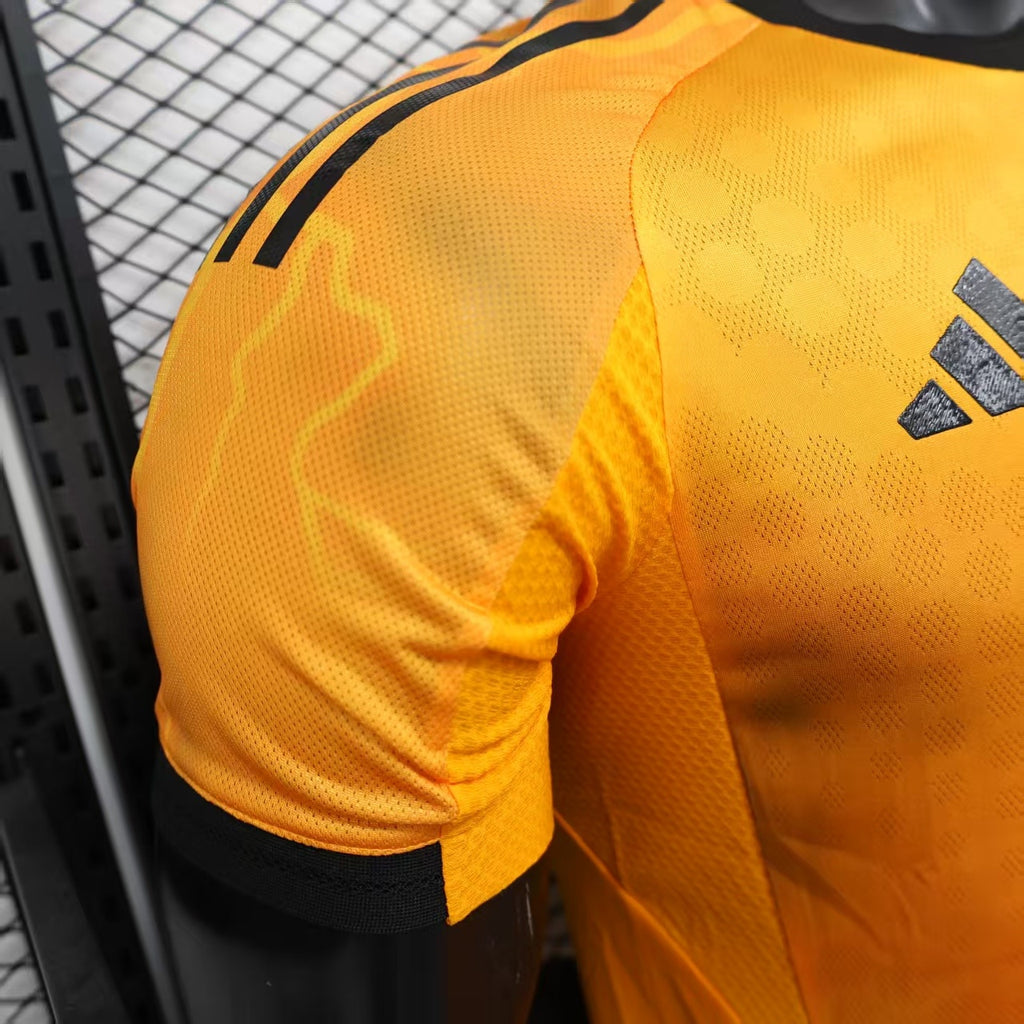Orange football jersey sleeve and side seam with adidas marks