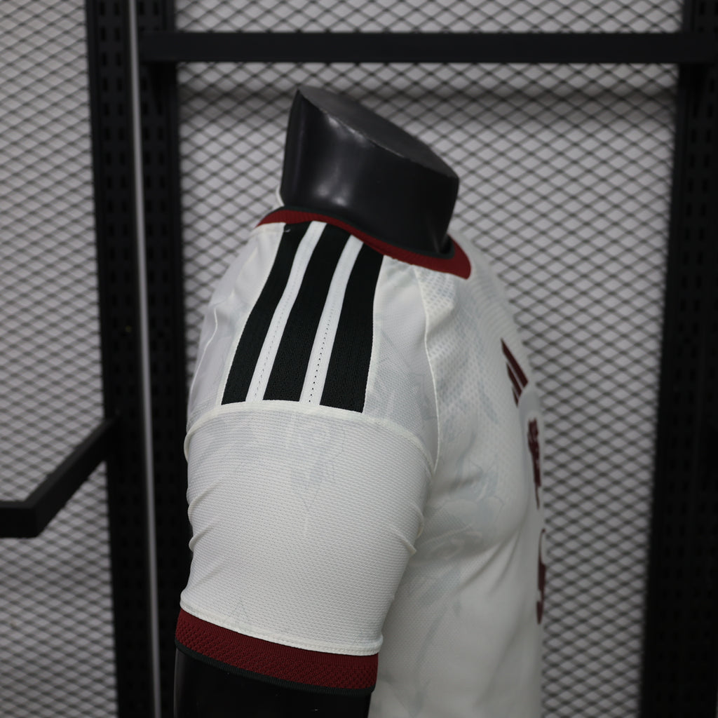 White Manchester United third player shirt sleeve with black three stripes and maroon band