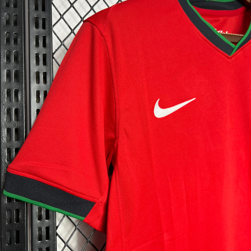 Red football jersey sleeve with Nike swoosh and green-trim cuff
