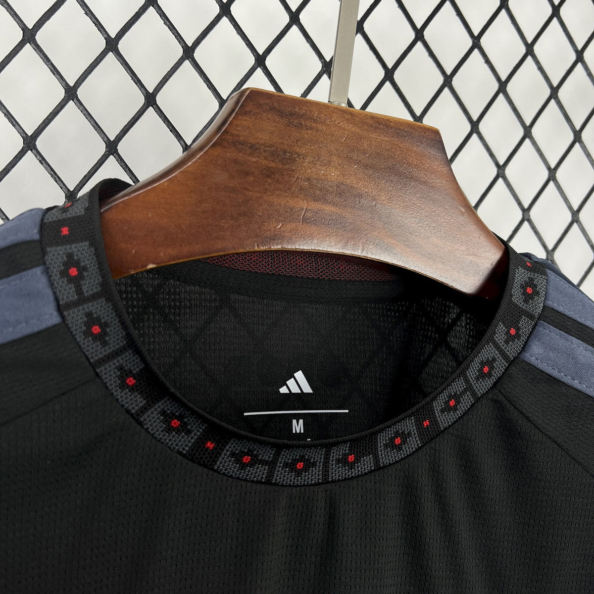 Black football jersey neck with Adidas logo and size tag 'M' inside