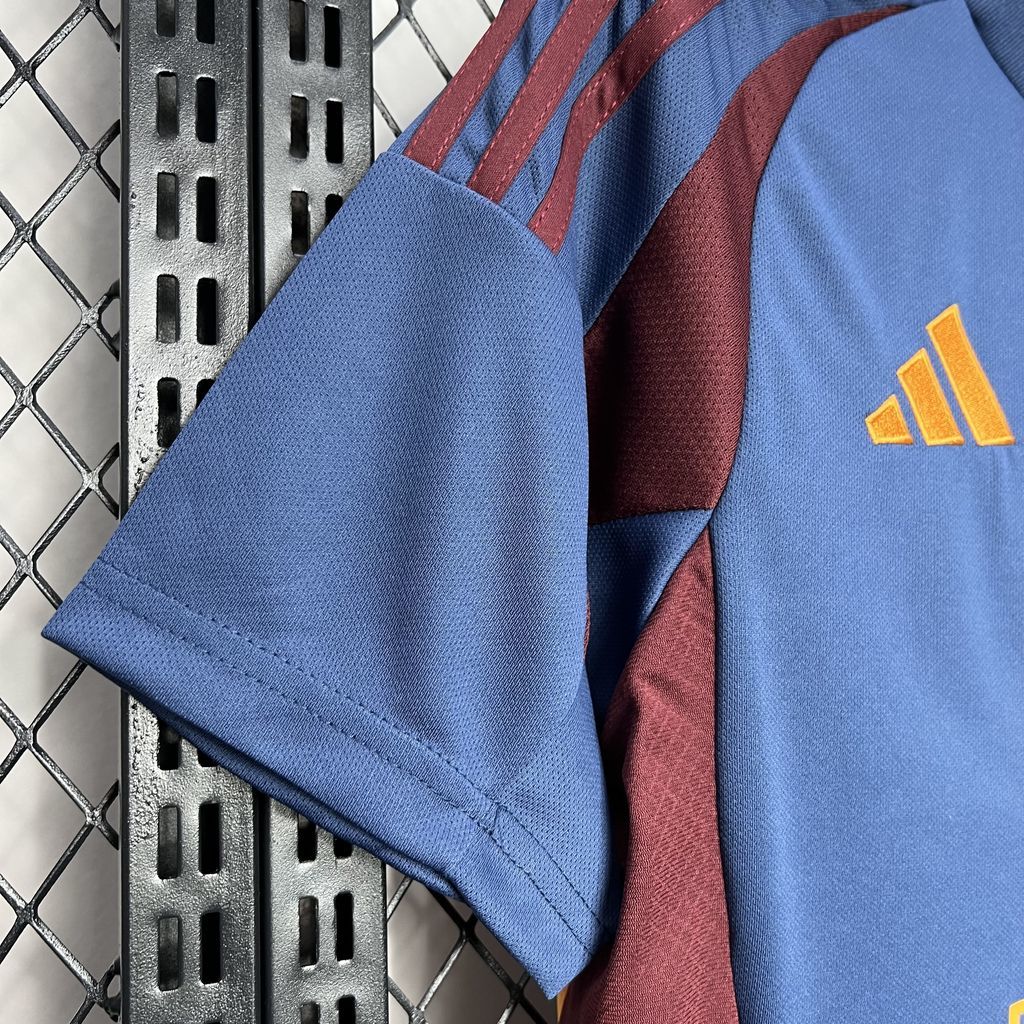 Close-up of blue jersey sleeve cuff with maroon stripes and yellow adidas logo