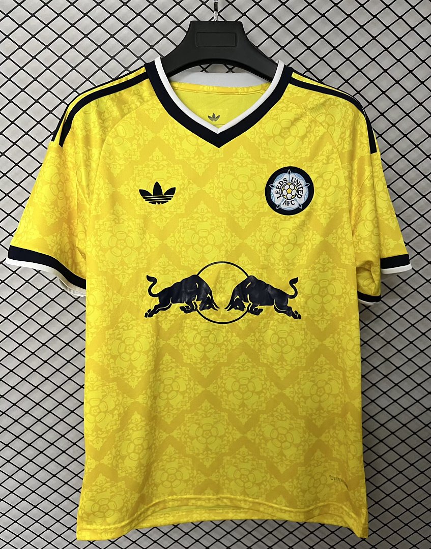 Yellow Leeds United away fan jersey with black V-neck trim, club crest, and bull graphic