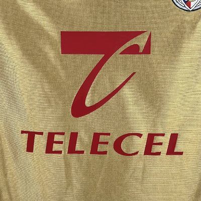 Yellow jersey front close-up with red Telecel sponsor text