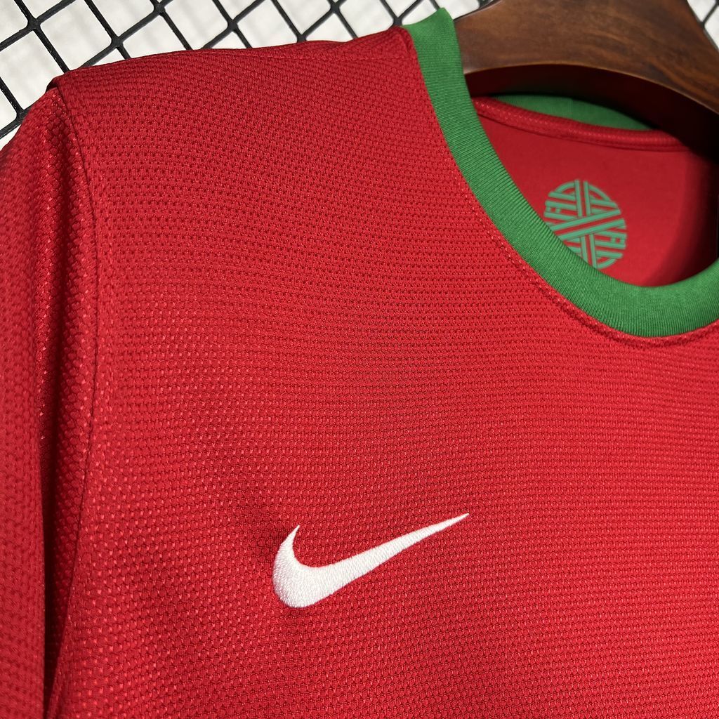 Red textured soccer jersey close-up with Nike swoosh on the chest.