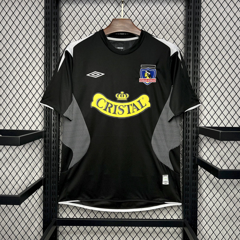 Black football jersey with Cristal logo and Colo-Colo crest on the chest