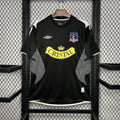 Black football jersey with Cristal logo and Colo-Colo crest on the chest