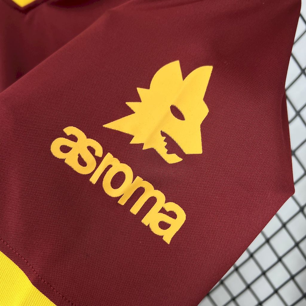 Yellow Roma sponsor graphic on maroon sleeve