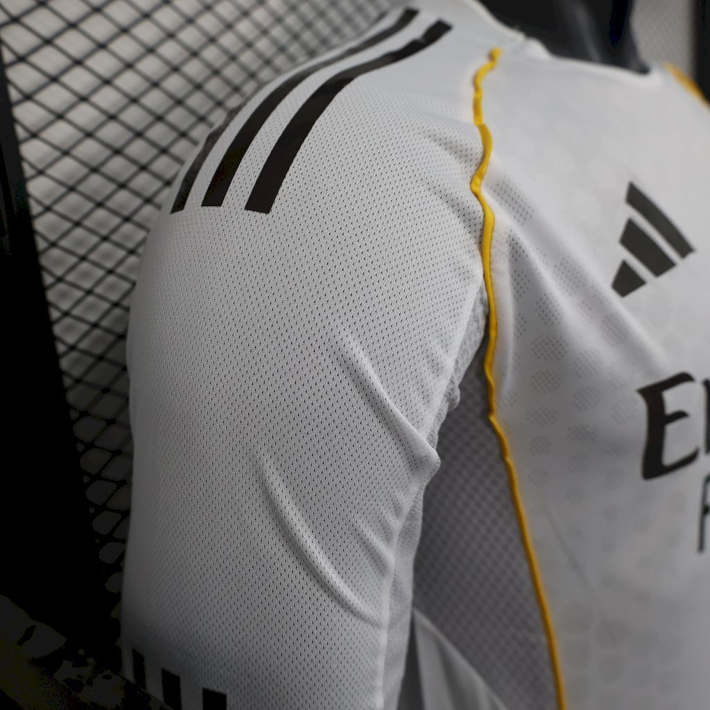 Real Madrid home jersey shoulder detail, white long-sleeve with black adidas stripes
