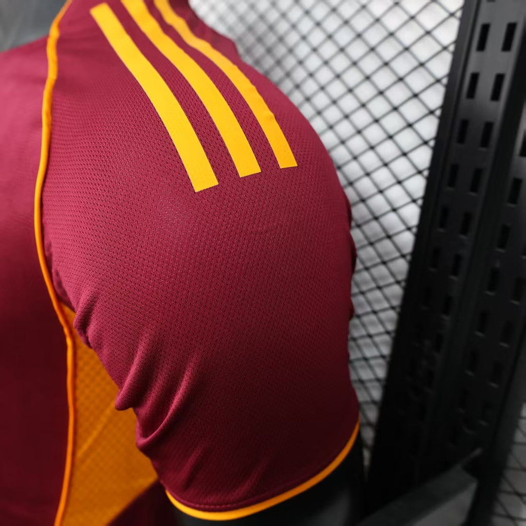 Maroon sleeve panel with bold yellow adidas stripes along the shoulder.