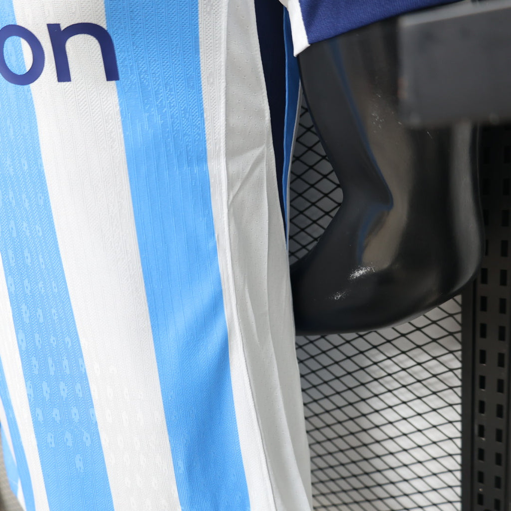 Soccer jersey sleeve and side hem with blue-and-white stripes