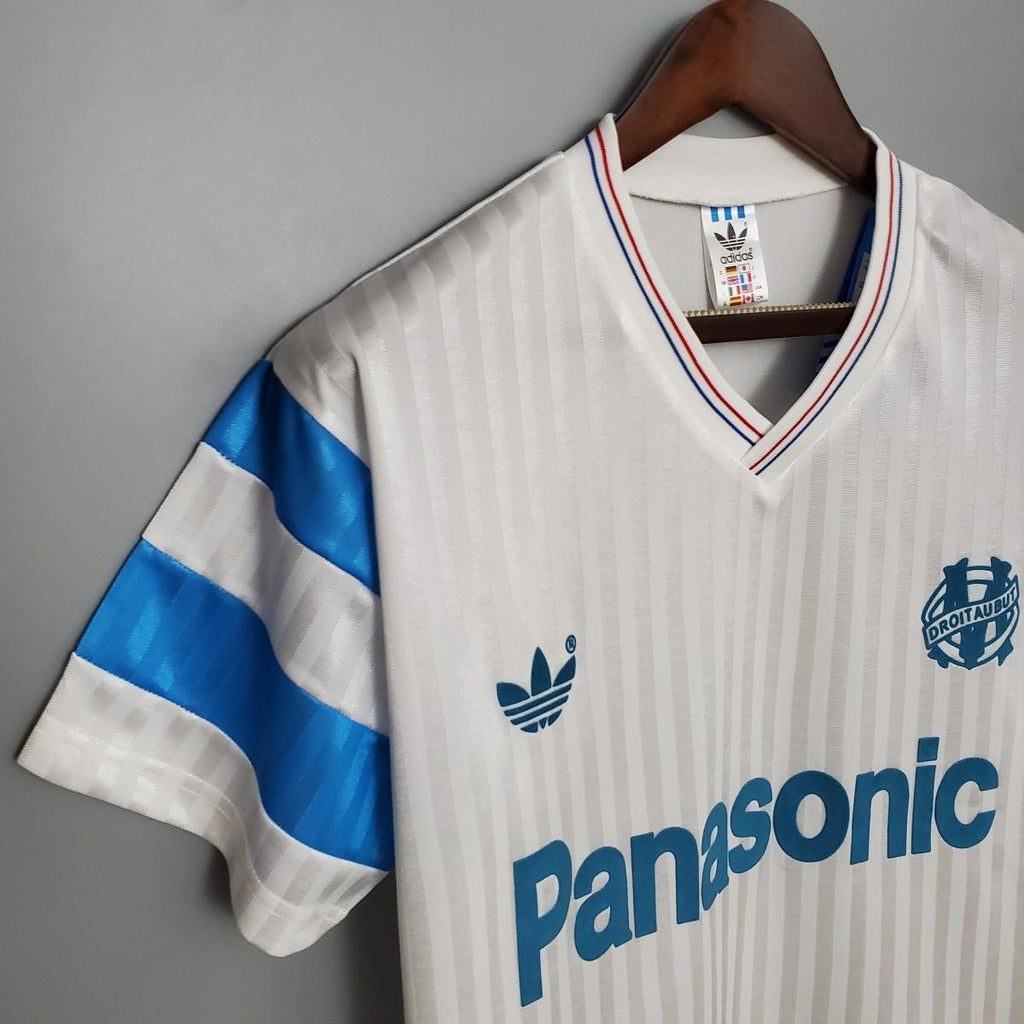 White home soccer jersey with blue sleeve stripes and Panasonic sponsor logo