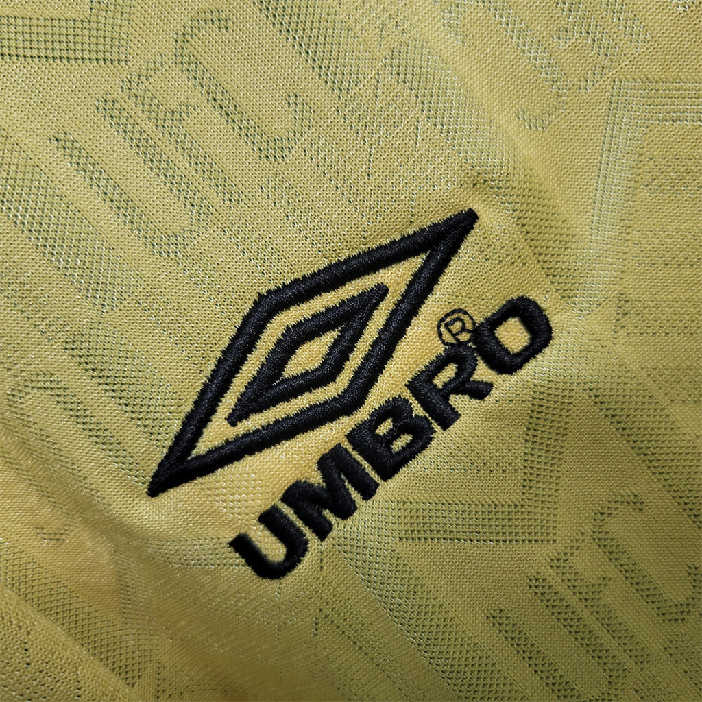 Umbro diamond logo and UMBRO lettering on yellow fabric
