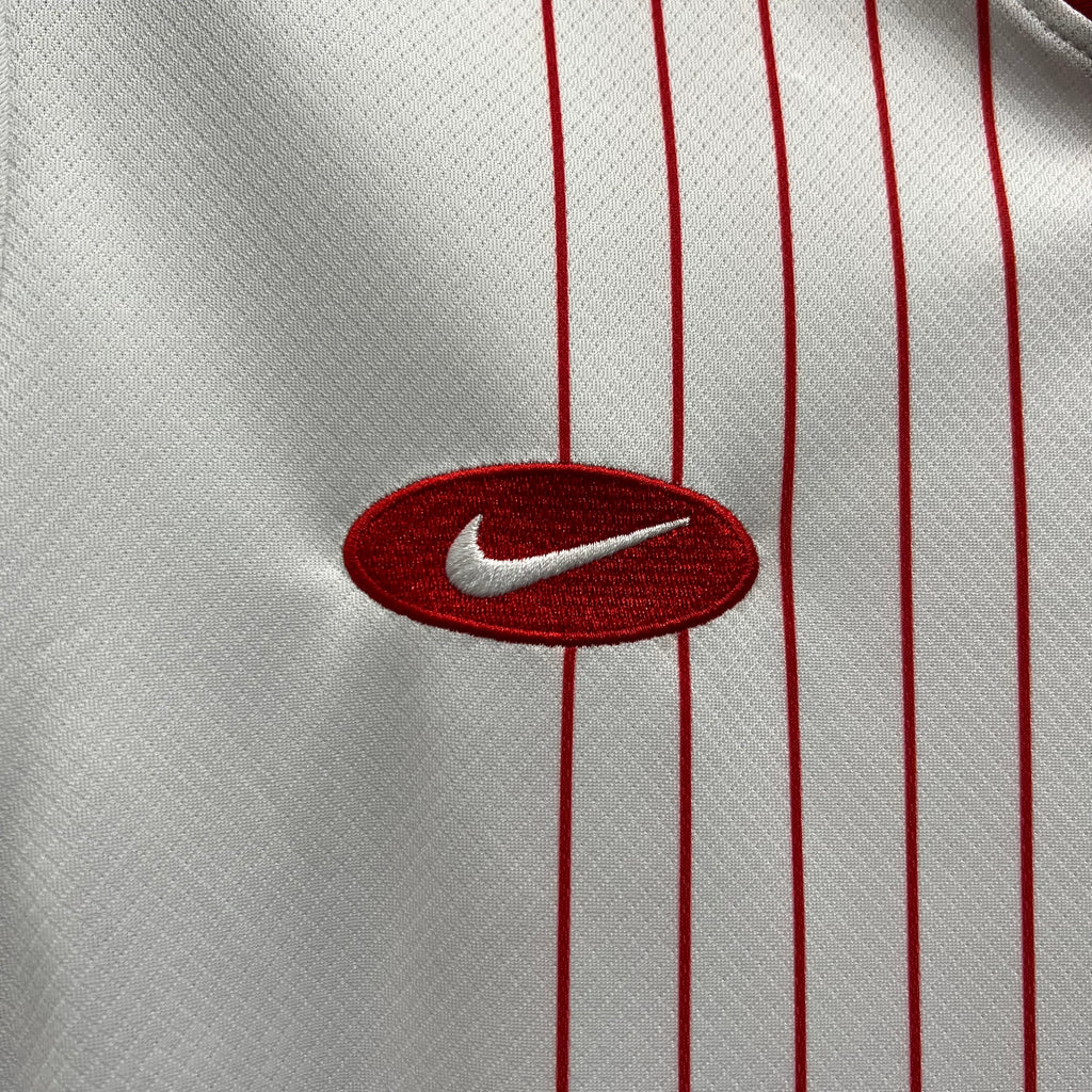 Nike swoosh logo on white jersey with red vertical stripes