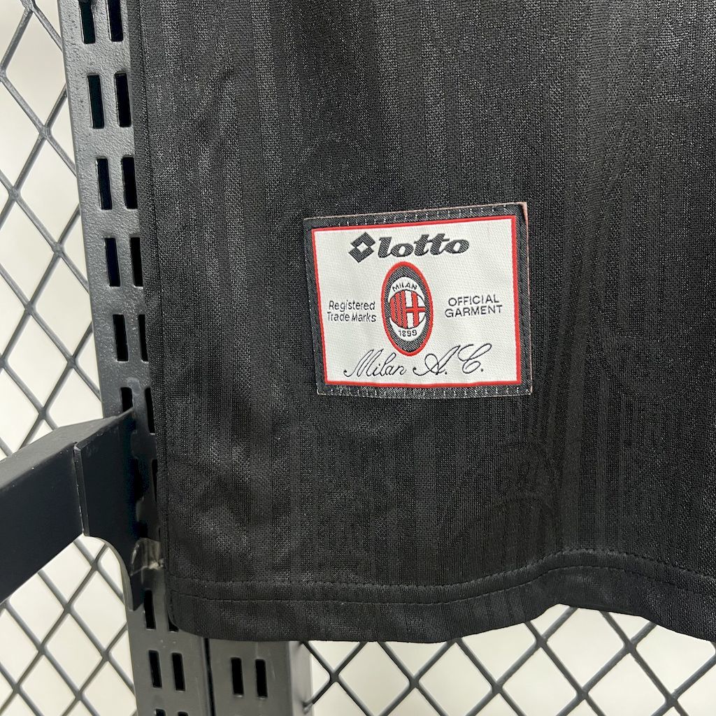 Black jersey side label patch with lotto branding and Milan A.C. text