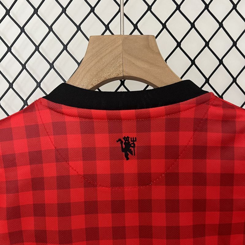 Kids red plaid Manchester United jersey with black V-neck collar and small back details