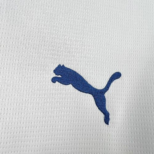 Blue Puma logo on white football jersey fabric