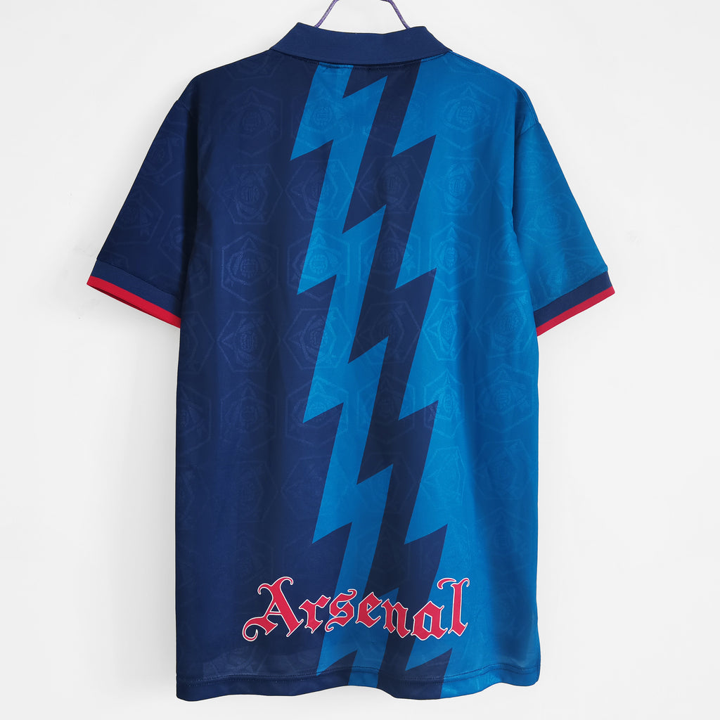Retro football jersey back, dark blue with light blue lightning and red 'Arsenal' print