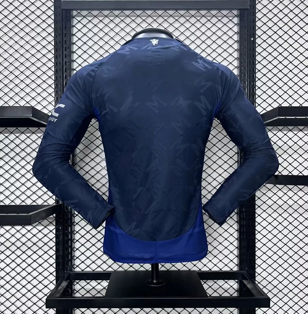 Dark blue Manchester United away long-sleeve jersey, back view with logo details
