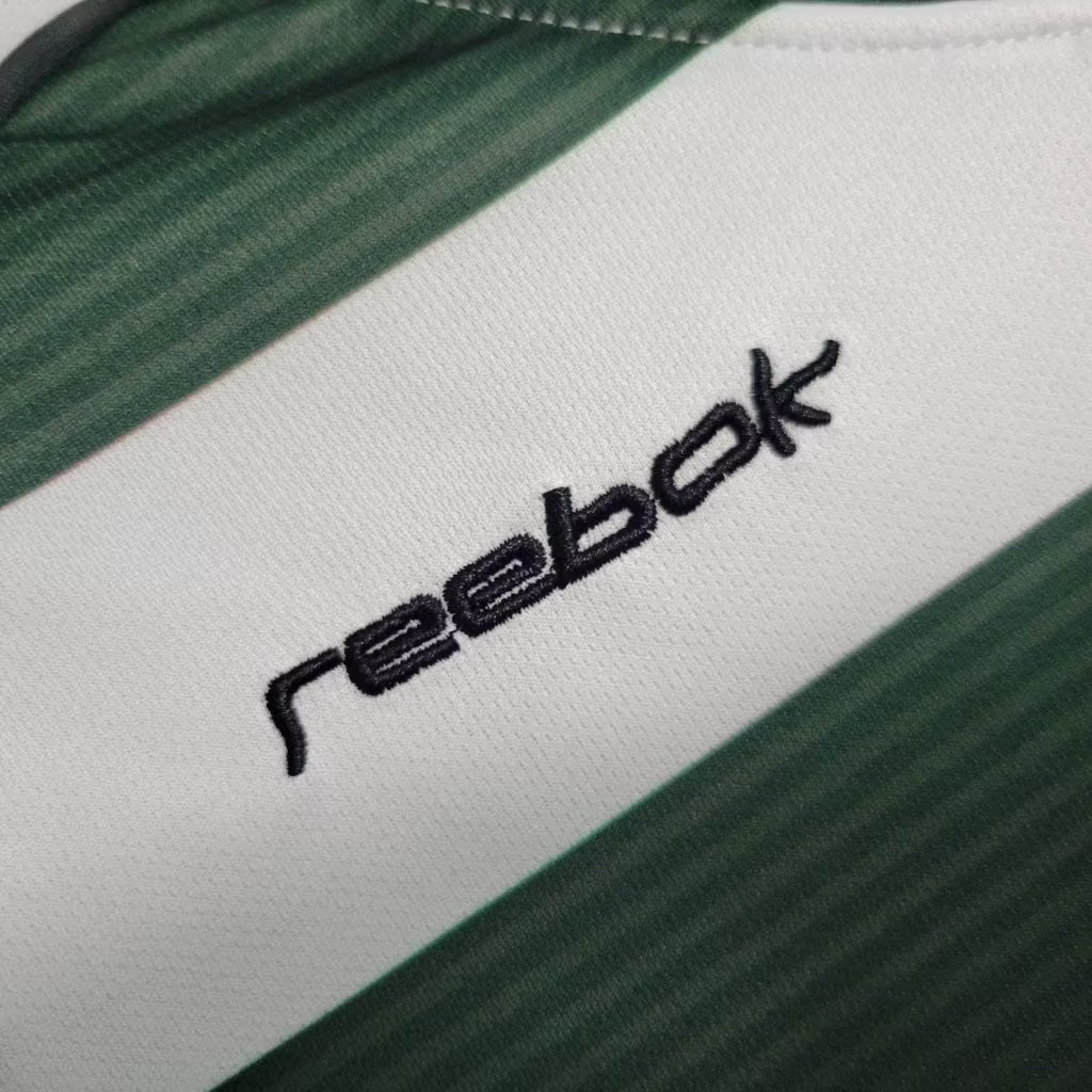 Jersey fabric detail: Reebok logo on white with green shoulder trim