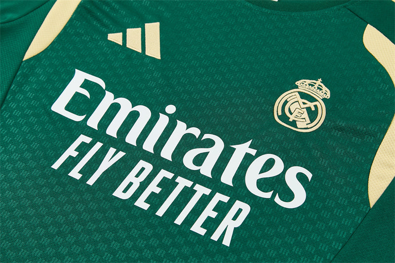 Green training jersey close-up with white sponsor print and Real Madrid crest