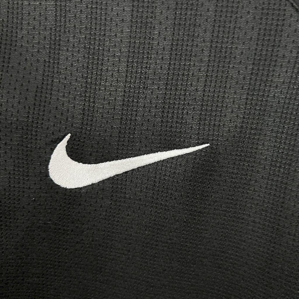 Retro away football jersey close-up of white Nike swoosh on black fabric