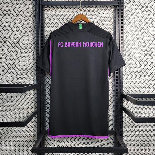 Black FC Bayern away soccer jersey back view with purple trim and text