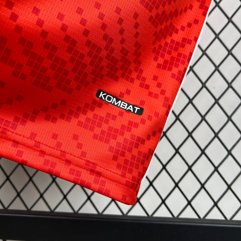 Red jersey hem with KOMBAT text and textured check pattern