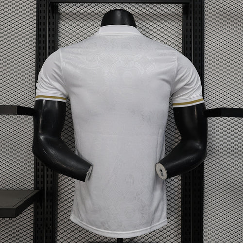White Bayern Munich player jersey back view with gold-trim shoulder stripes