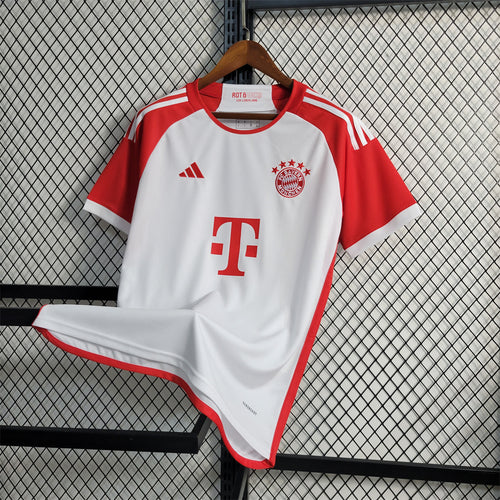 Red and white Bayern Munich home fan jersey with crest, Adidas stripes, and sponsor logo