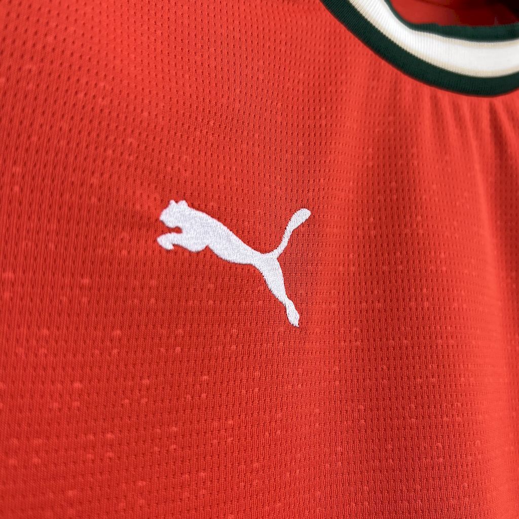 White Puma cat logo on red textured jersey