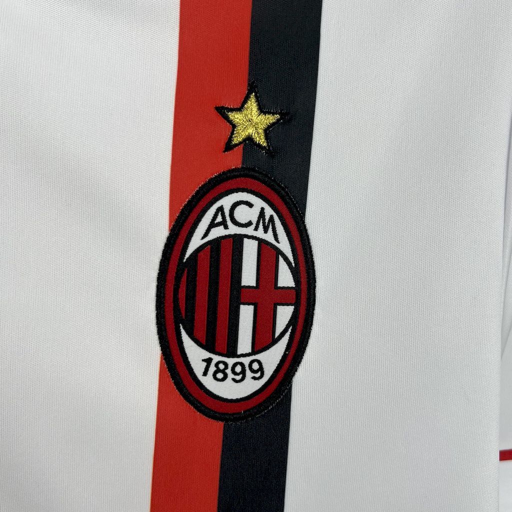 AC Milan crest on white jersey with red-and-black vertical stripe