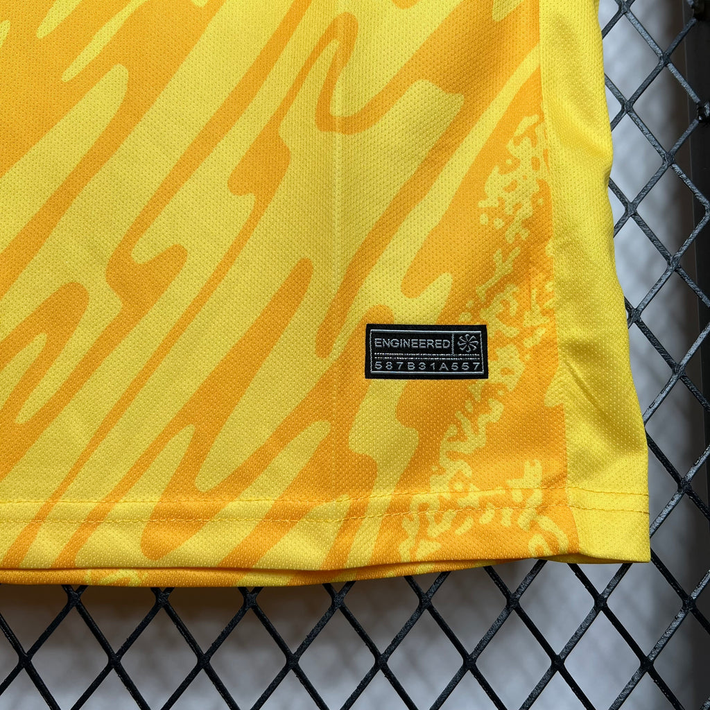 Yellow jersey fabric close-up with ENGINEERED label and size code patch