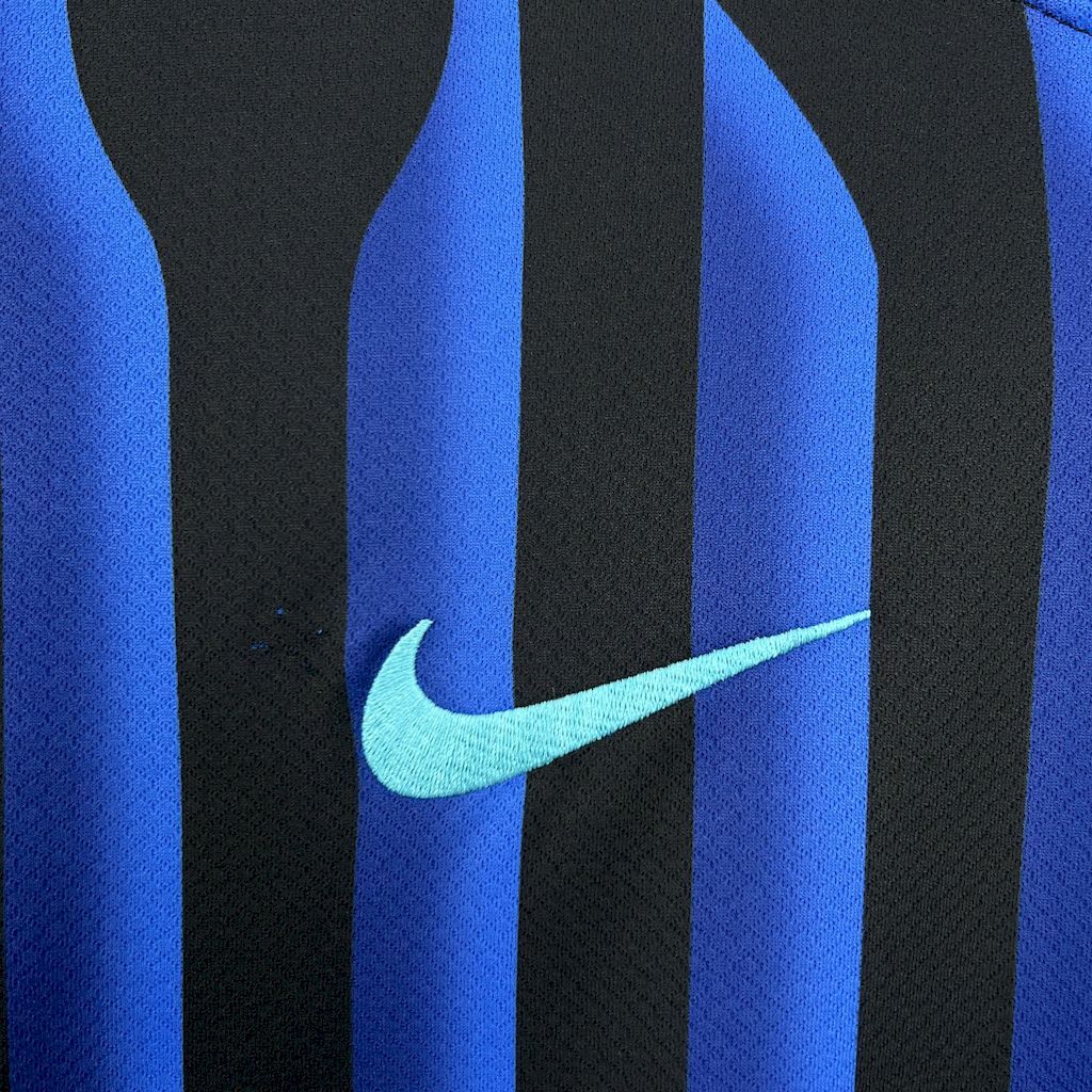 Inter Milan fan jersey close-up of Nike swoosh over blue stripe on black panel