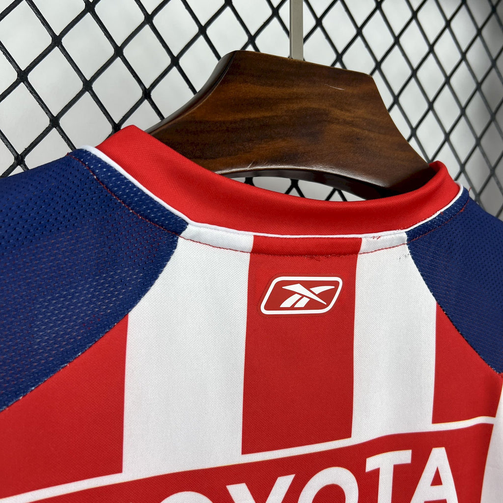 Retro soccer jersey collar with red trim and logo patch on the neckline