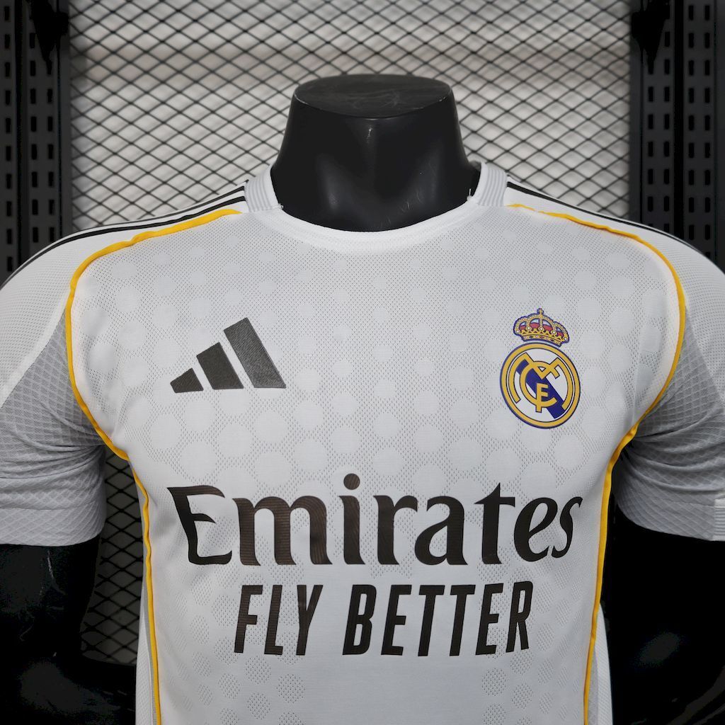 White football jersey with adidas logo and large "Emirates Fly Better" text, yellow piping