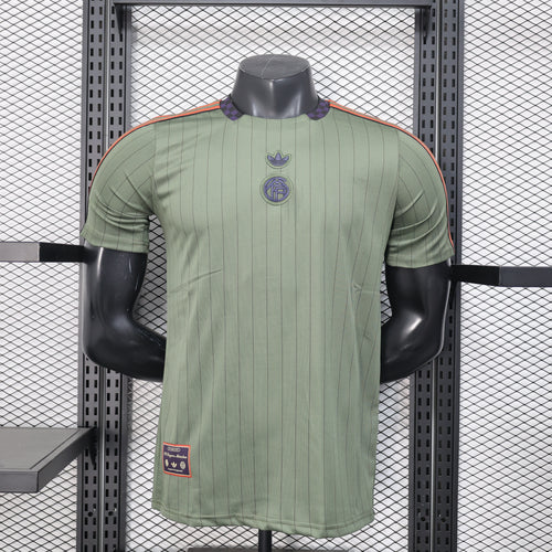 Men's dark green football jersey with short sleeves and embroidered crest on chest
