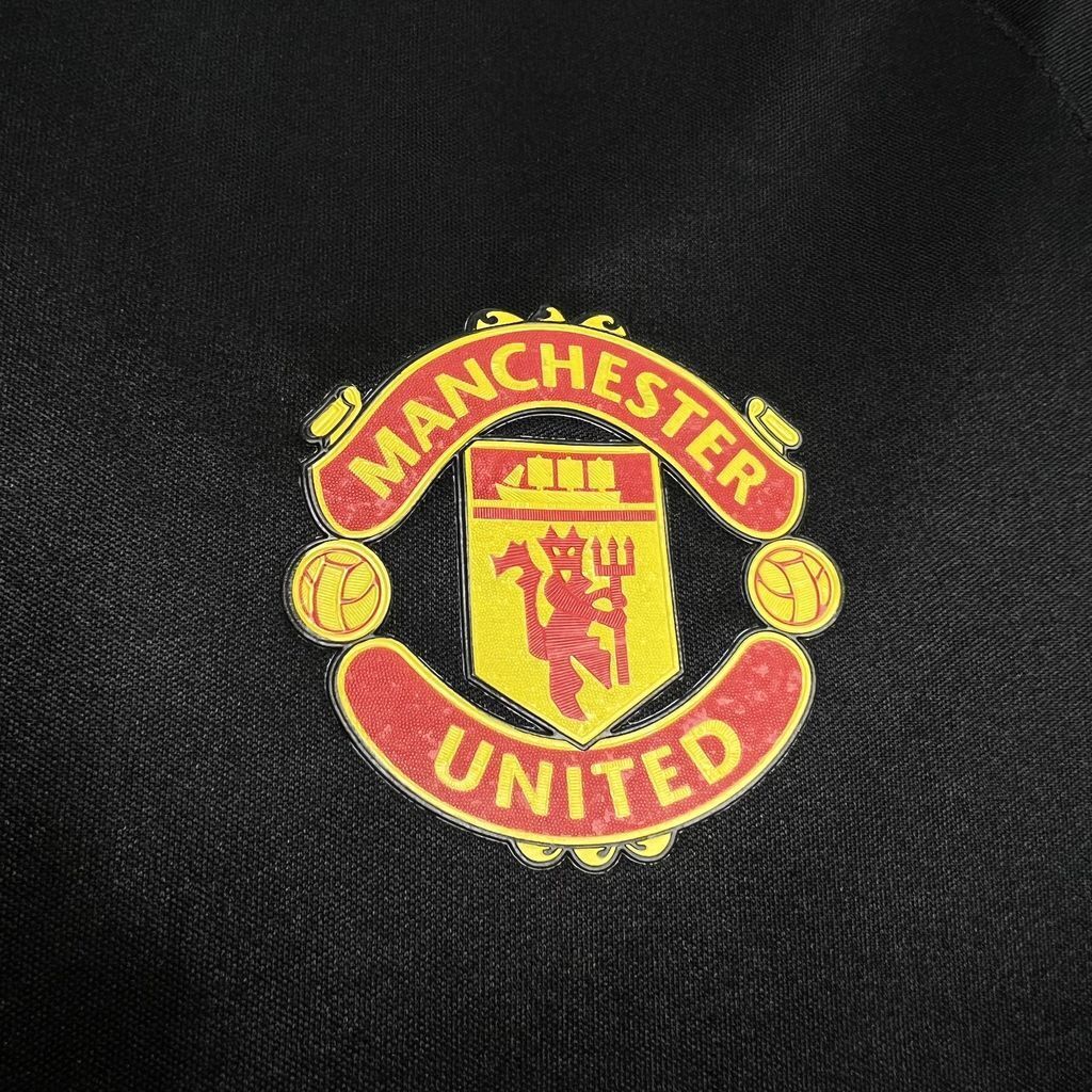 Manchester United club crest patch on black soccer jersey