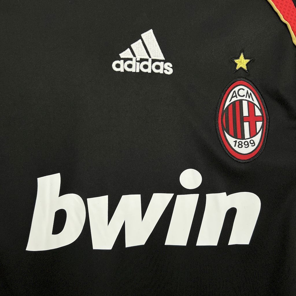 Black jersey front with adidas logo, ACM crest, and large white sponsor bwin text