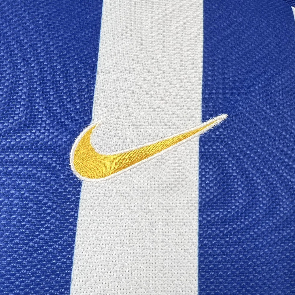 Yellow Nike swoosh logo on a white vertical stripe of a blue soccer jersey