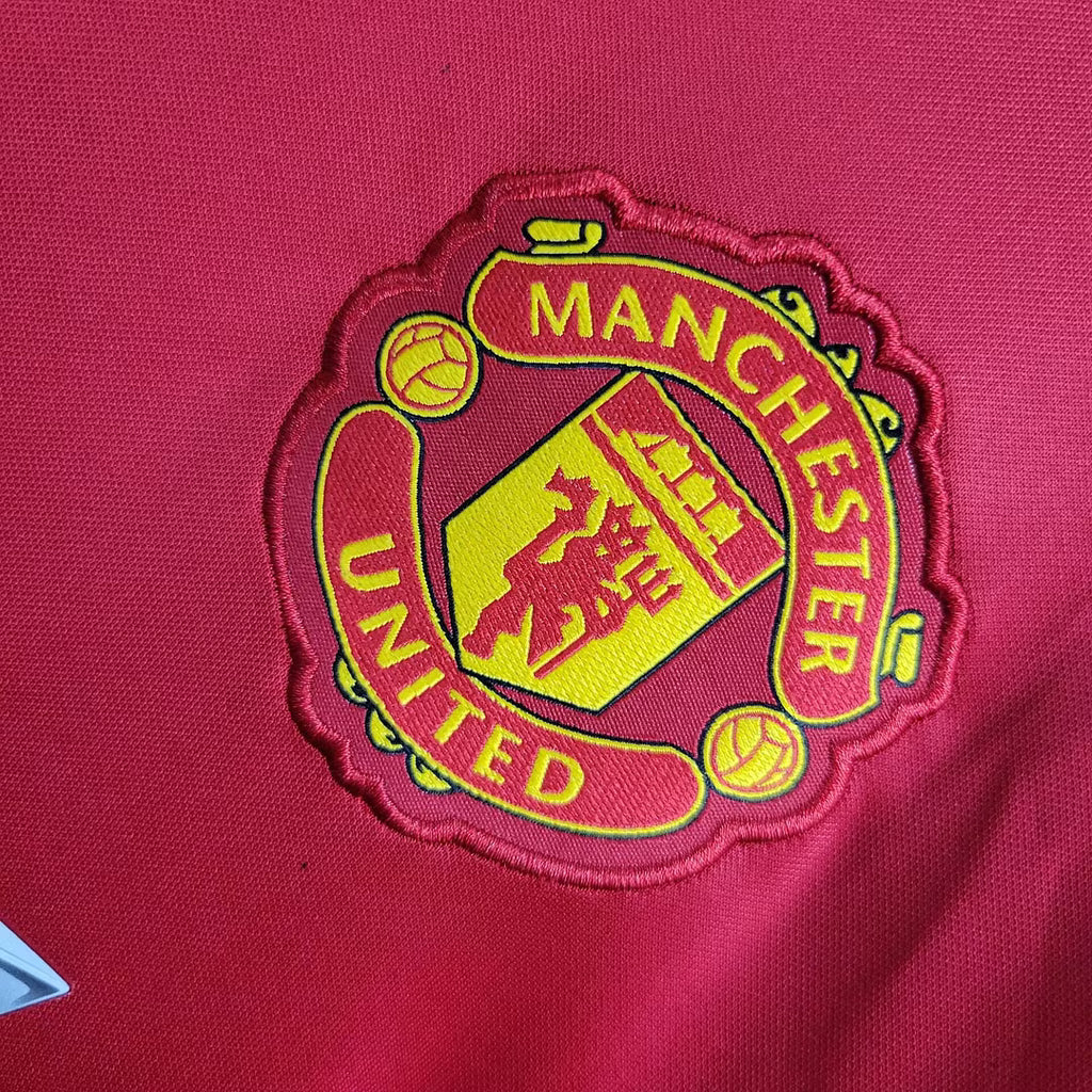 Red jersey crest patch with Manchester United text and yellow shield
