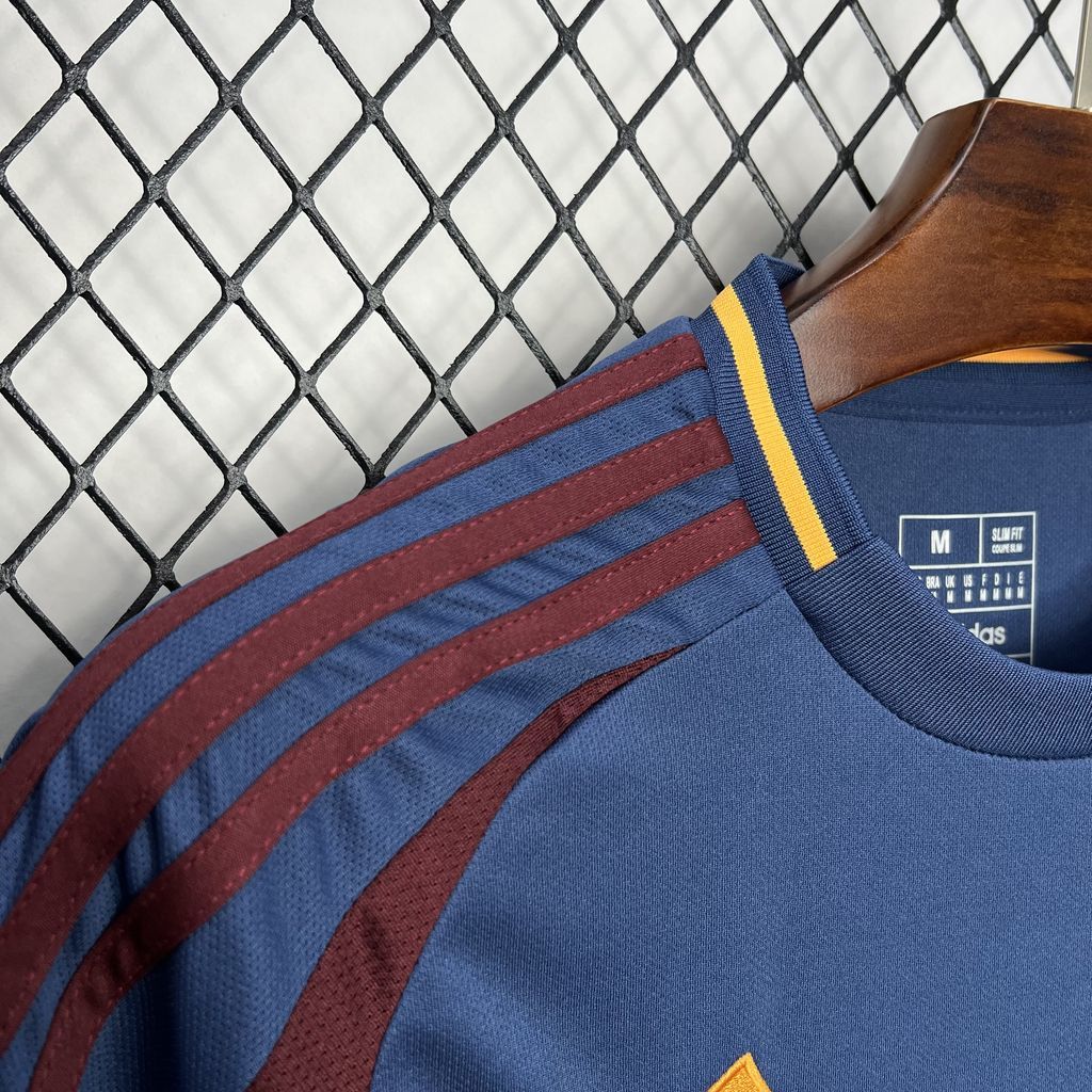 Neckline close-up of blue jersey with maroon stripes, yellow trim, and size label