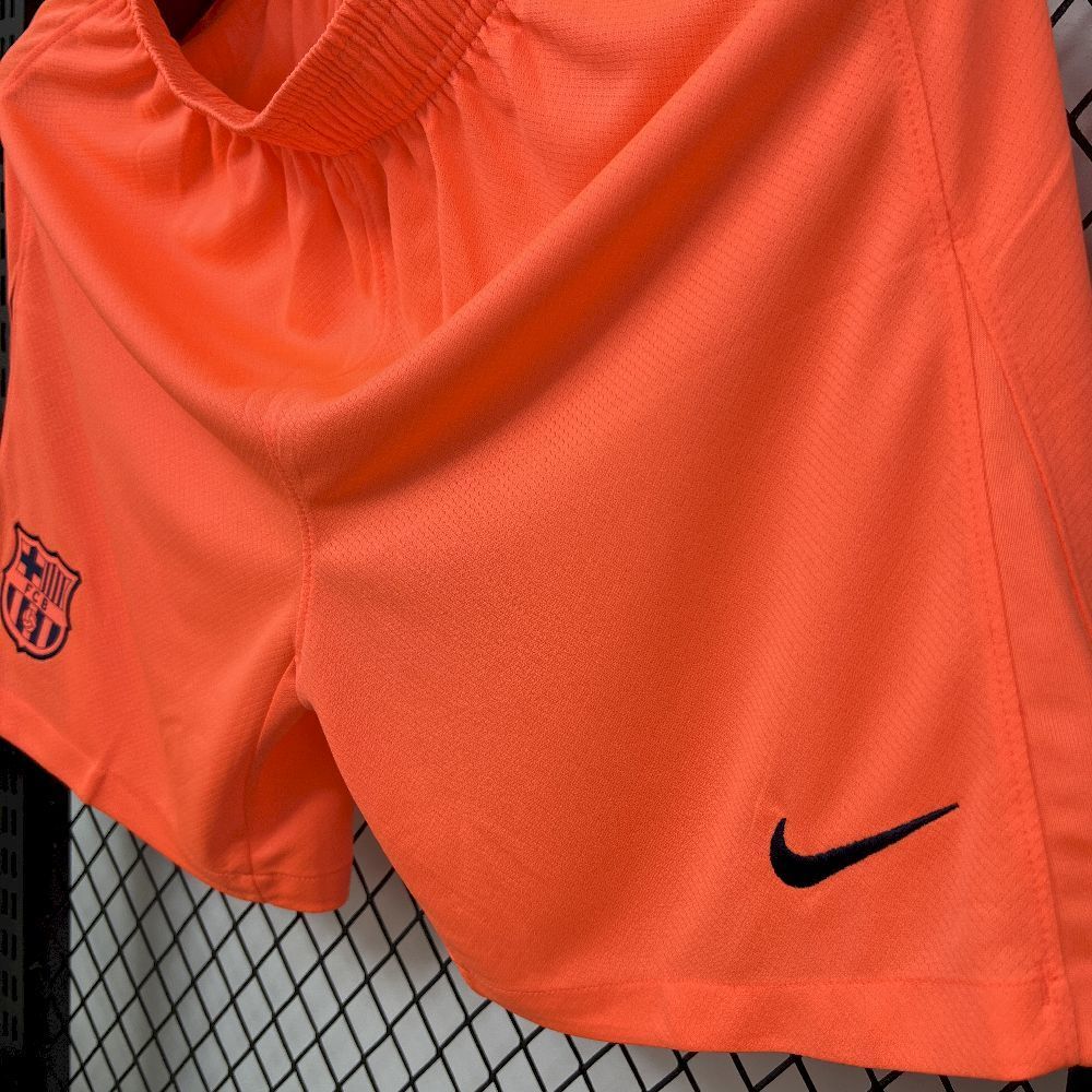 Orange football shorts with FC Barcelona crest detail and Nike swoosh
