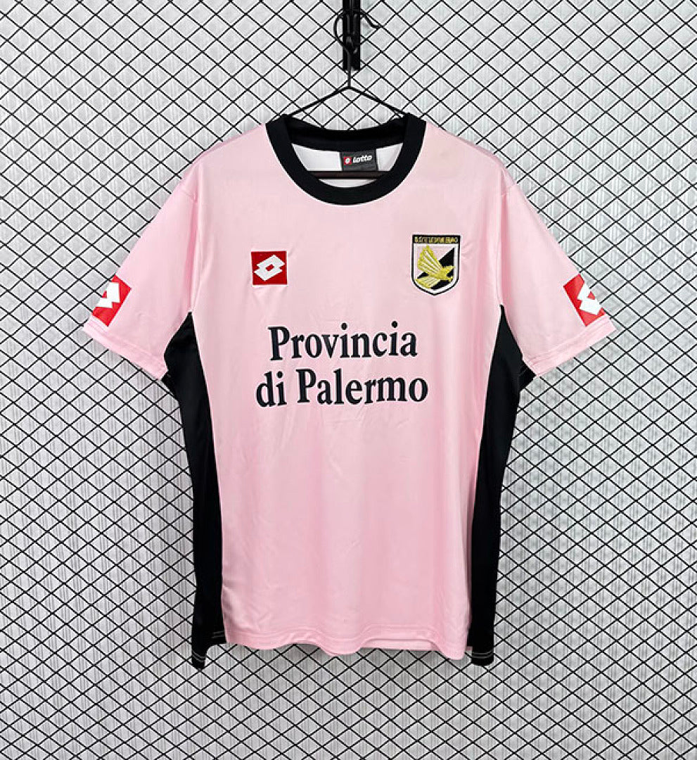 Pink Palermo home football jersey with black collar, crest badges, and Provincia di Palermo text