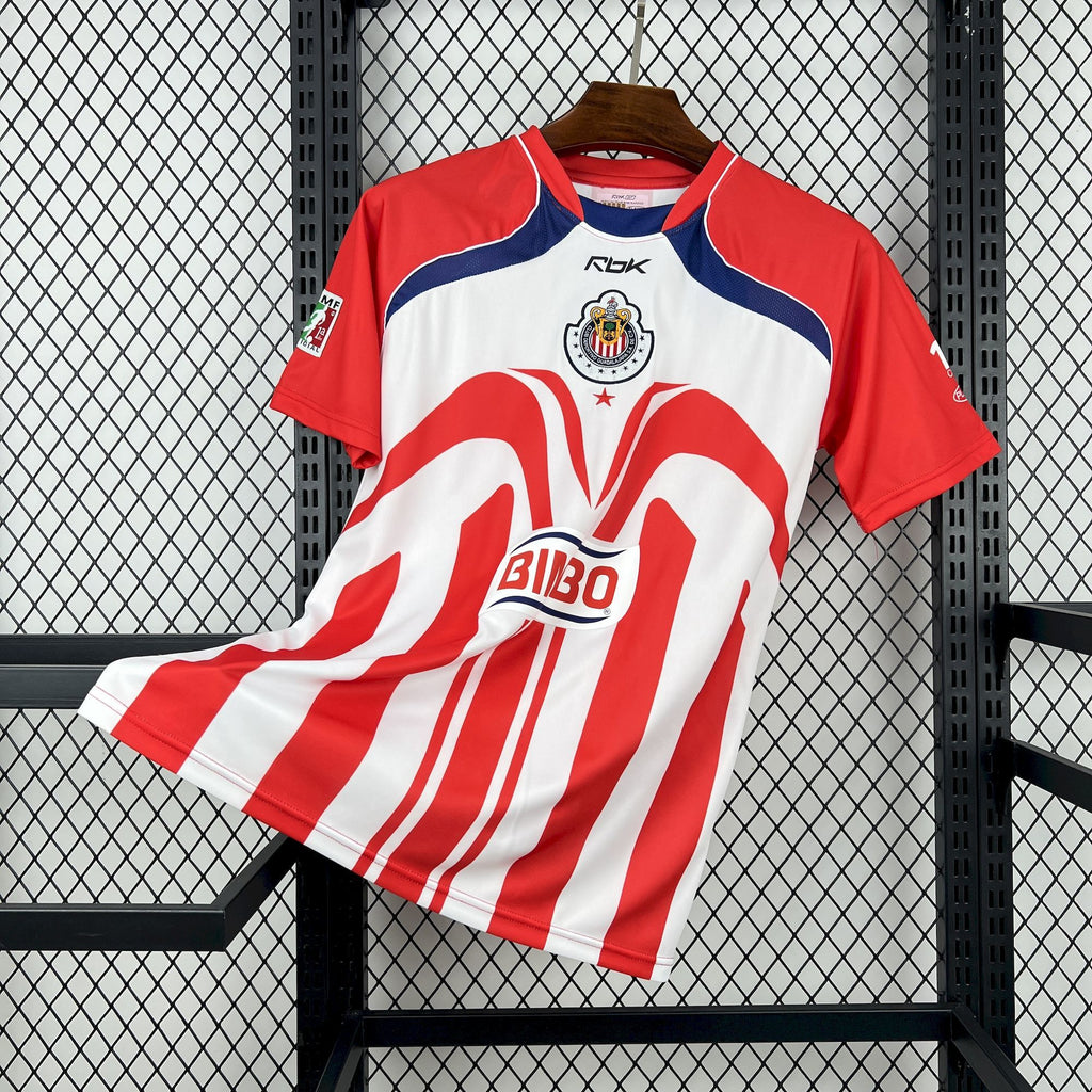 Retro soccer jersey with red-and-white stripes, blue trim, and Chivas crest
