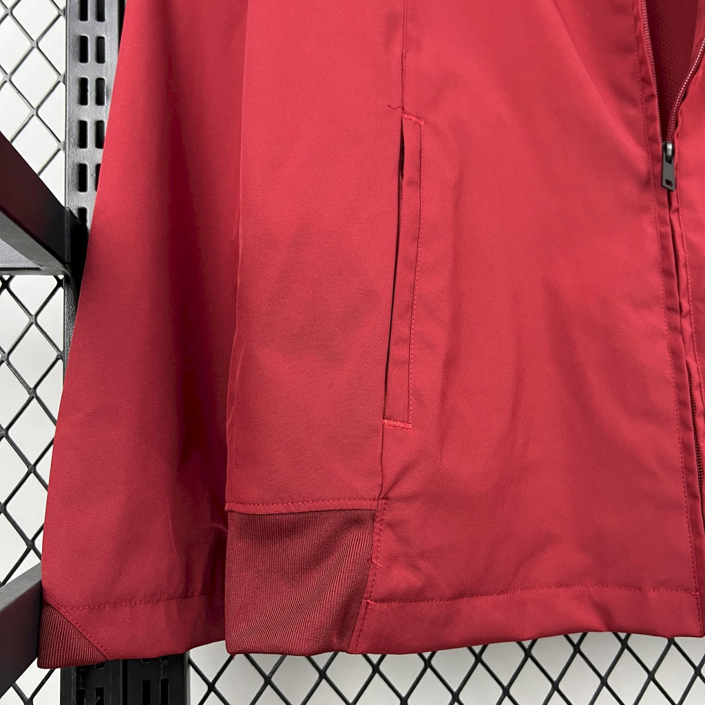 Red windbreaker jacket side panel with vertical seam and zip pocket opening