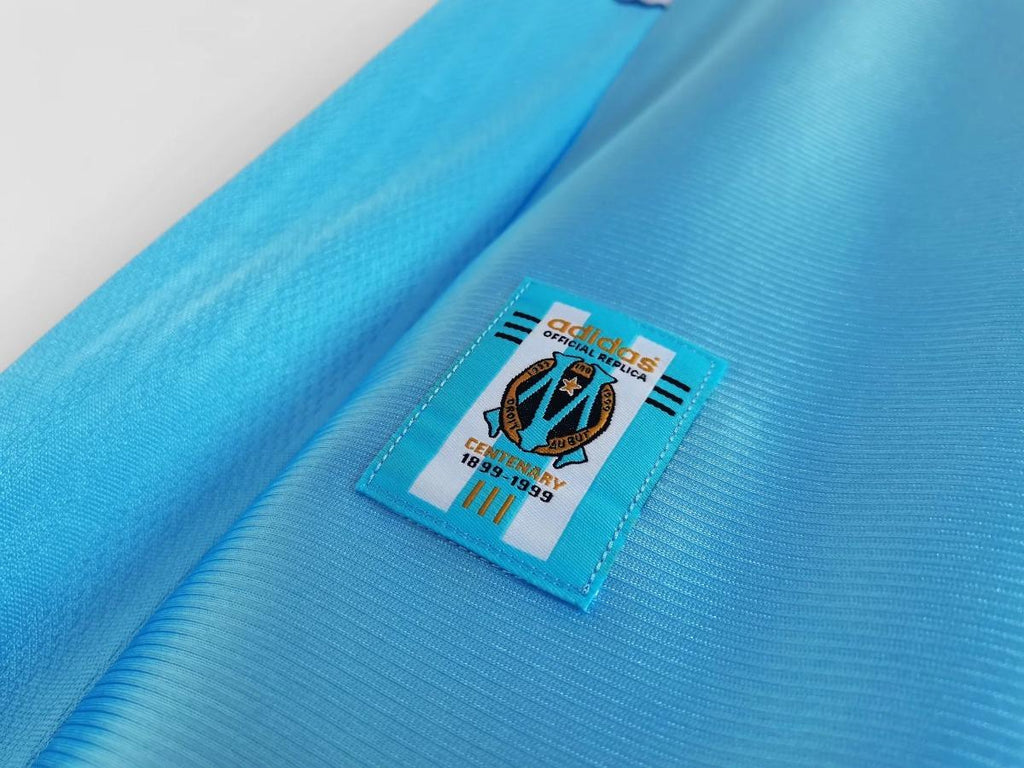 Sky blue soccer jersey sleeve label patch with adidas branding and club crest