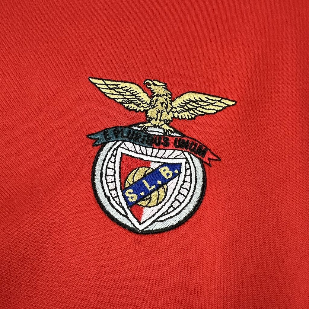 Red soccer jersey chest crest with wings and circular Benfica emblem