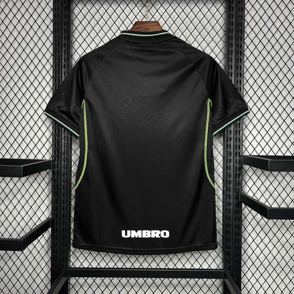Black Manchester United third soccer jersey, Umbro logo at hem, green trim stripes