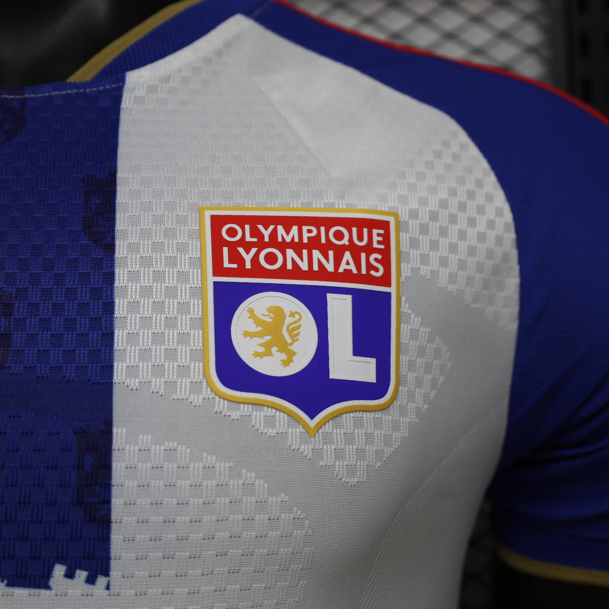 Olympique Lyonnais crest patch on white jersey with blue sleeve